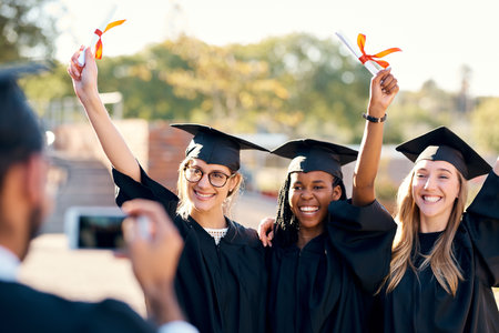 Its a day for celebration. a group of students taking photos on graduation day.の写真素材
