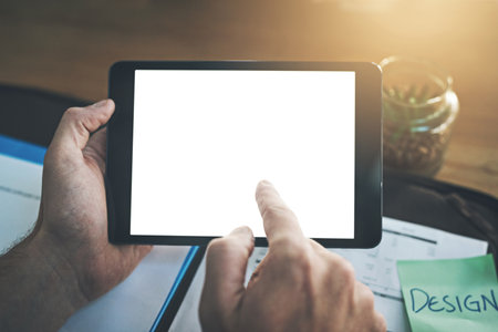 Its a website worth checking out. an unrecognisable businessperson using a digital tablet in an office.の写真素材