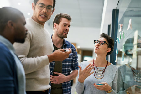 Not everyone will agree with your idea but pitch it. a group of designers brainstorming with notes...