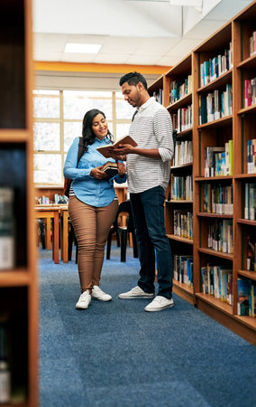 This book would be quite helpful for our assignment. two university students working together in the...