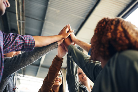 College. Bring it on. a group of young students joining their hands together in solidarity on...