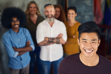 Together, were unstoppable. Portrait of a group of designers standing in an office.の写真素材