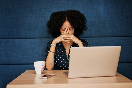 I have to think long and hard on this. a young female designer looking stressed while trying to work...