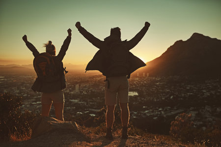 Loving the feeling of accomplishment after bouldering to the top. a couple celebrating after reaching the summit.の写真素材