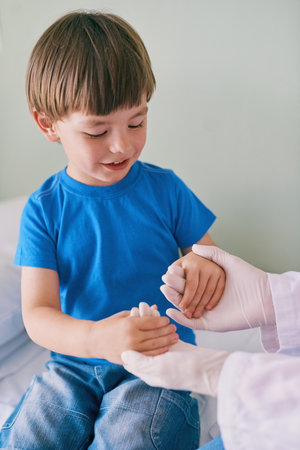 What strong hands you have. a little boy holding his doctors hands.の写真素材