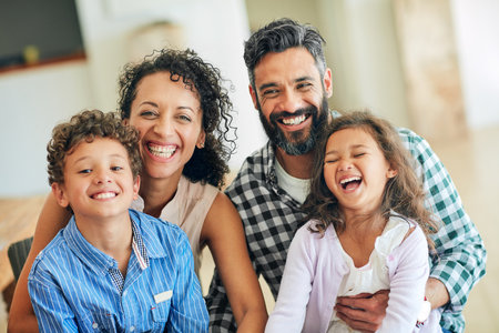 Home is where we are happy together. Portrait of a happy family with young children posing together at home.の写真素材