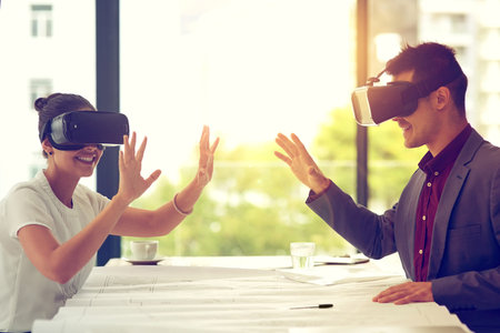 Theres no end to the reach of technology. two businesspeople wearing VR headsets while working...