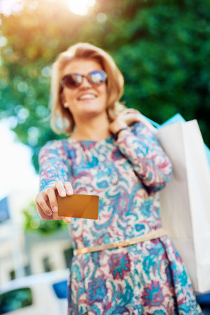 Charge it to my credit card. Portrait of an attractive young woman showing you her credit card.