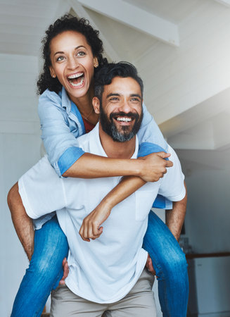 Shes got him at her beck and call. a relaxed couple enjoying the day at home together.の写真素材