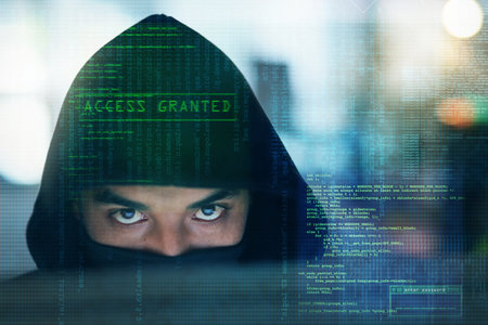 Getting up to no good. Portrait of a serious computer hacker hacking into a computer in an office.の写真素材
