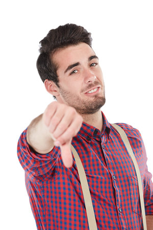 Sorry, not today. Studio portrait of a young man showing a thumbs down gesture against a white...