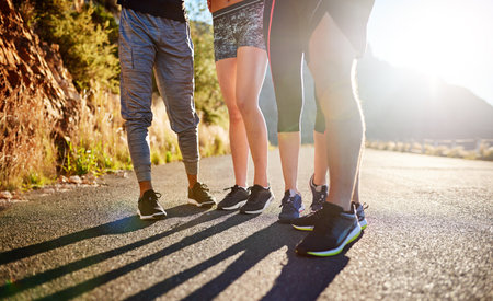 Covering the miles together. a fitness group out for a run together.の写真素材