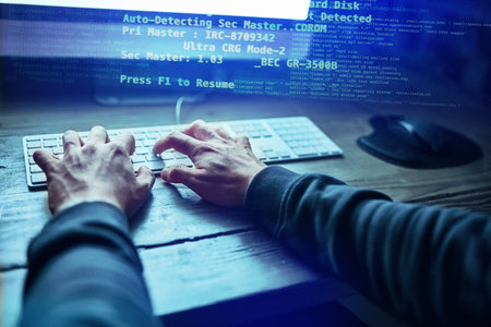 Coding through the night. an unidentifiable hacker using a computer late at night.