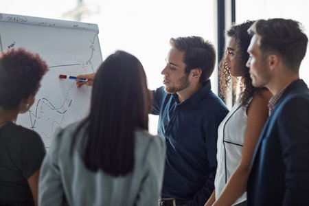 Success is one good idea away. a well dressed businessman giving a presentation to his colleagues in the boardroom.の写真素材
