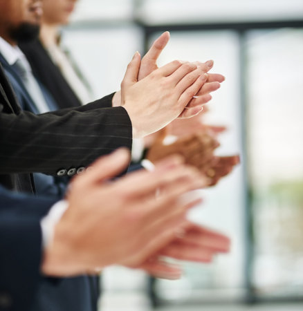 Everyones motivated after a great presentation. Closeup shot of a group of executives clapping while...