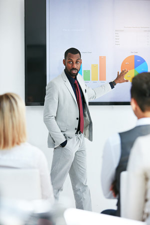Delivering a killer presentation. a businessman giving a presentation to his colleagues at work.