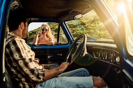I found adventure when I met you..a young woman standing by the window of a pickup truck.