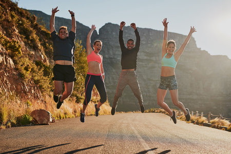 Victory belongs to the most persevering. a fitness group celebrating after a good workout.