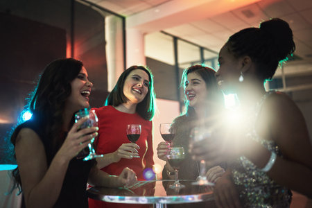 Catching up over some drinks. a group of friends having drinks at a social event.の写真素材