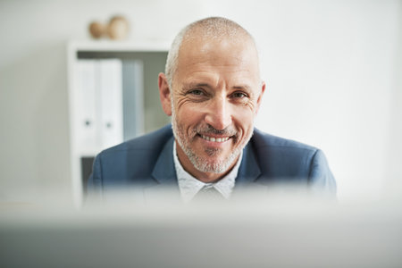 Ready for business. Portrait of a mature businessman sitting in a modern office.の写真素材