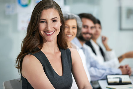 Success is our main priority. Portrait of a group of businesspeople sitting together in a modern...