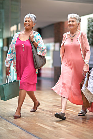 Theyre here for the sale. Full length shot of a two senior women out on a shopping spree.の写真素材