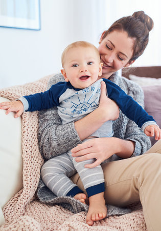 Im having so much fun with mum. Portrait of a baby boy bonding with his mother at home.
