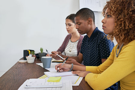 Fully focused on their meeting. a group of colleagues having a meeting in a modern office.