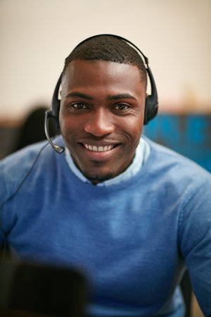 Im here to help. Cropped portrait of a businessman wearing a headset in the office.