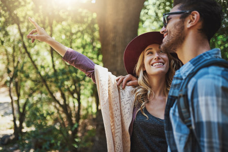 Isnt that amazing. a happy young couple exploring nature together.の写真素材