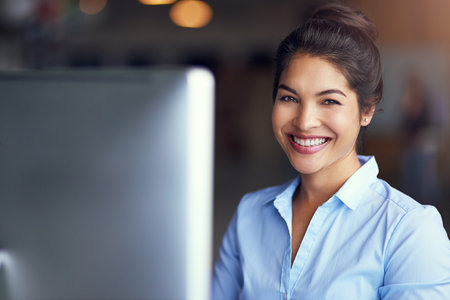 Shes a star employee. Portrait of a young businesswoman sitting at her office computer.の写真素材