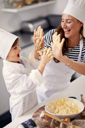Bake the world a better place. a mother and her son playing with cookie dough in the kitchen.の写真素材