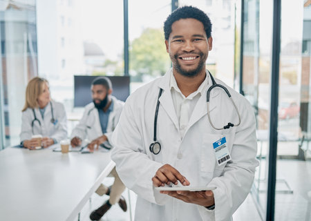 Portrait, black man and doctor with tablet, digital analysis and schedule surgery in hospital. African American male, medical professional and online research for cure, diagnosis and healthcare.の写真素材