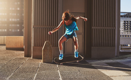 Think less, live more. a young woman skating in the city.の写真素材