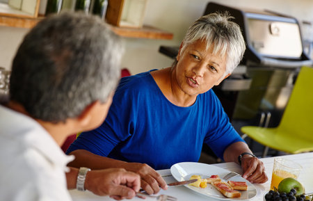 Are you enjoying the food. a happy senior couple enjoying a leisurely breakfast together at home.の写真素材