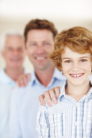 They got each others backs. Cropped portrait of a young boy standing with his father and...