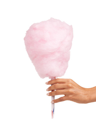 Spun for your delight. Cropped image of a woman holding some delicious candy floss while isolated on white.の写真素材
