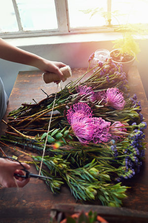 Making the simple, awesomely simple, thats creativity. a pretty floral bouquet being completed on a...
