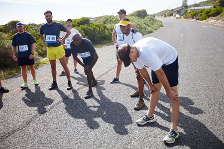 Mind over matter. a group of male runners getting focused before a road race.の写真素材