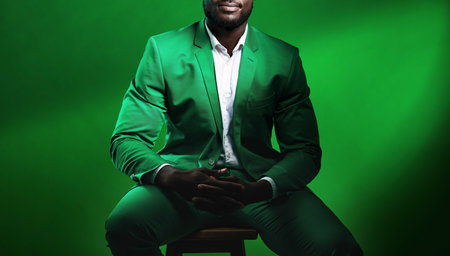 Fashion, suit and black man model with a formal outfit sitting on a chair while posing in a studio....