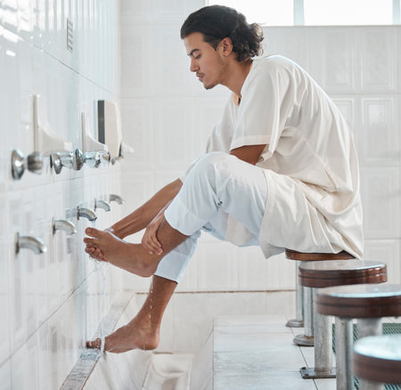 Muslim, water and man cleaning feet for ablution, wudu or spiritual purification hygiene for Islamic...