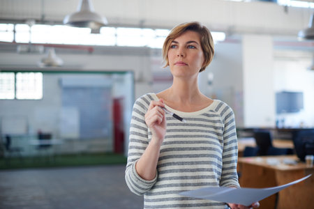 Shes got designs on success. an attractive designer standing in a large office.