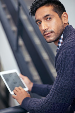 Digital planning made easy. A handsome businessman holding a digital tablet on a stairwell.