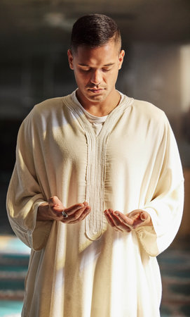 Man, muslim faith and praying in mosque for God, peace and mindfulness with traditional islamic clothes. Islam worship, prayer and spiritual balance for ramadan, religion and gratitude in Doha, Qatarの写真素材