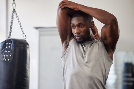 Black man stretching, boxing gym and training for fitness, wellness or focus for strong body. Man,...