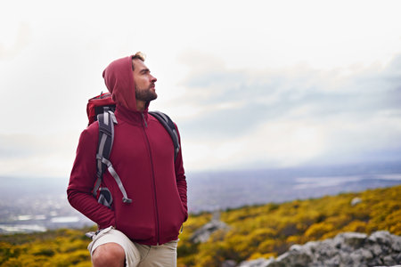 Wondering wildnerness. a young man enjoying a hike through the mountains.の写真素材