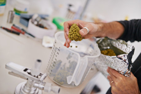 Precise ingredients for a great beer. a man handling hops in a microbrewery.の写真素材