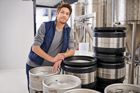 From our brewery to your pub. Portrait of a man working in a microbrewery.の写真素材