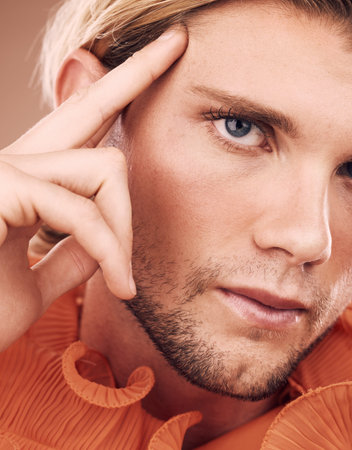 LGBT, fashion and face portrait of man with orange clothes, beauty or creative style on studio...