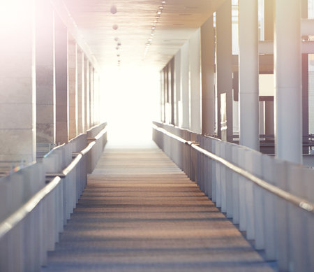 The light at the end of the...An empty corridor with a bright light at the end of it.の写真素材